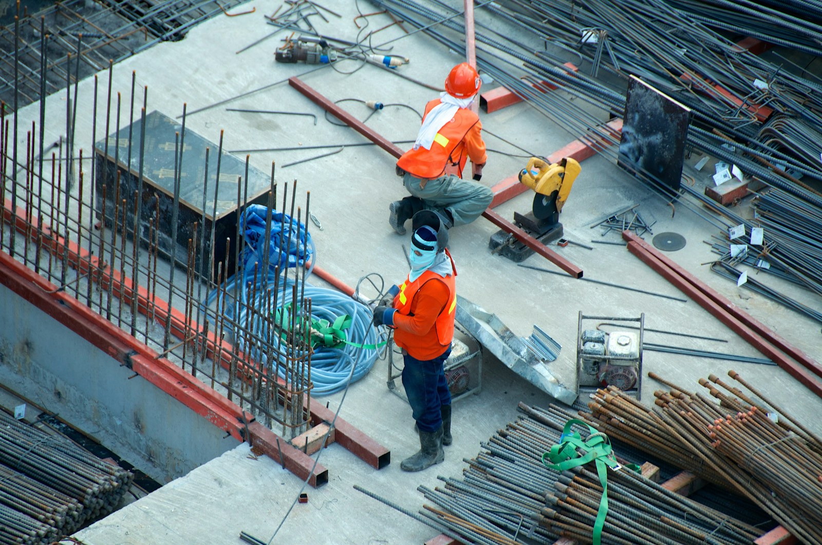 Construction workers surrounded by reinforcement steel on an active building site