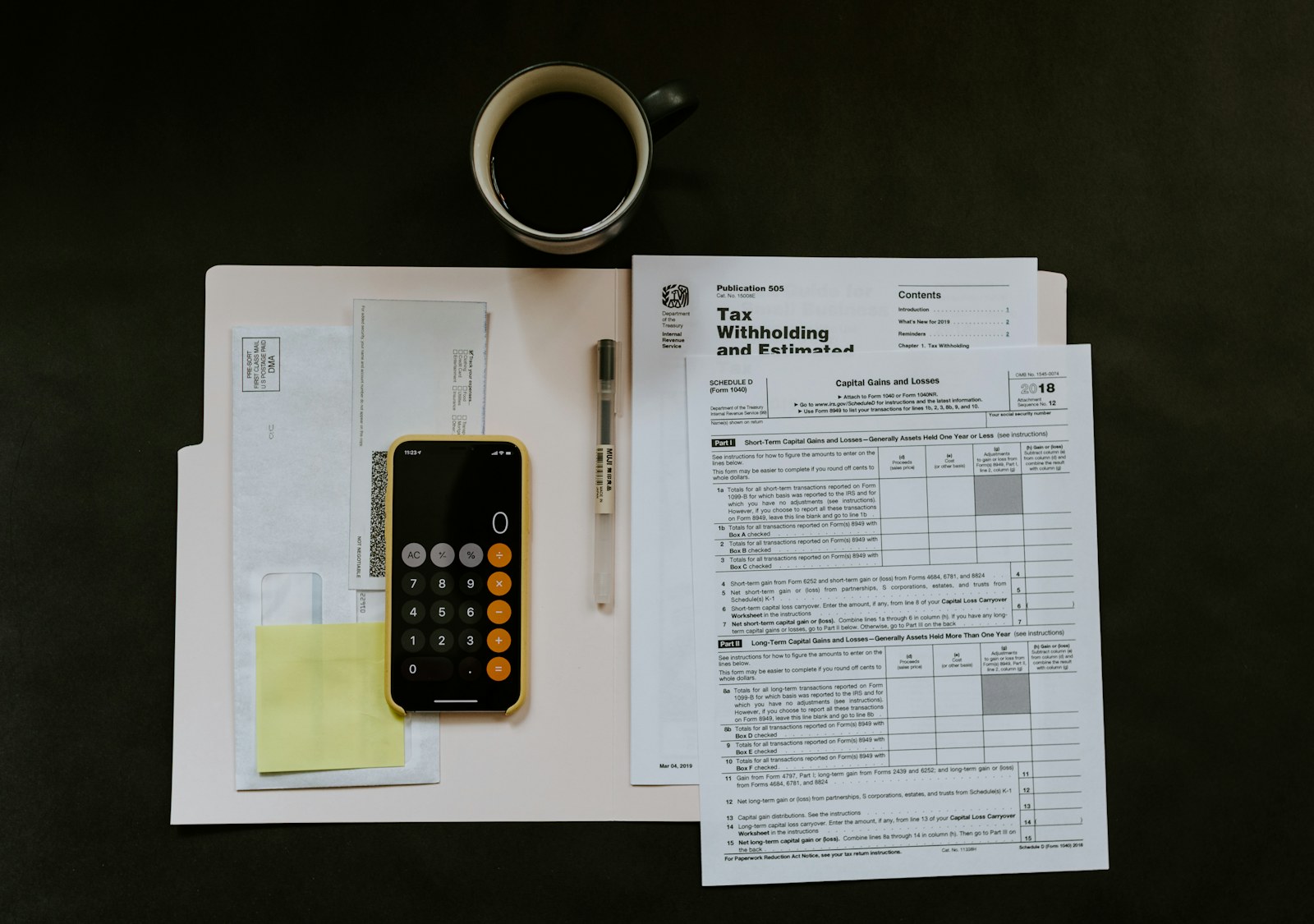 Calculator and financial documents used for project budget control