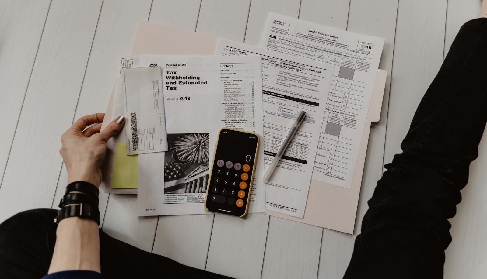 Calculator and cost documents used to review project expenses