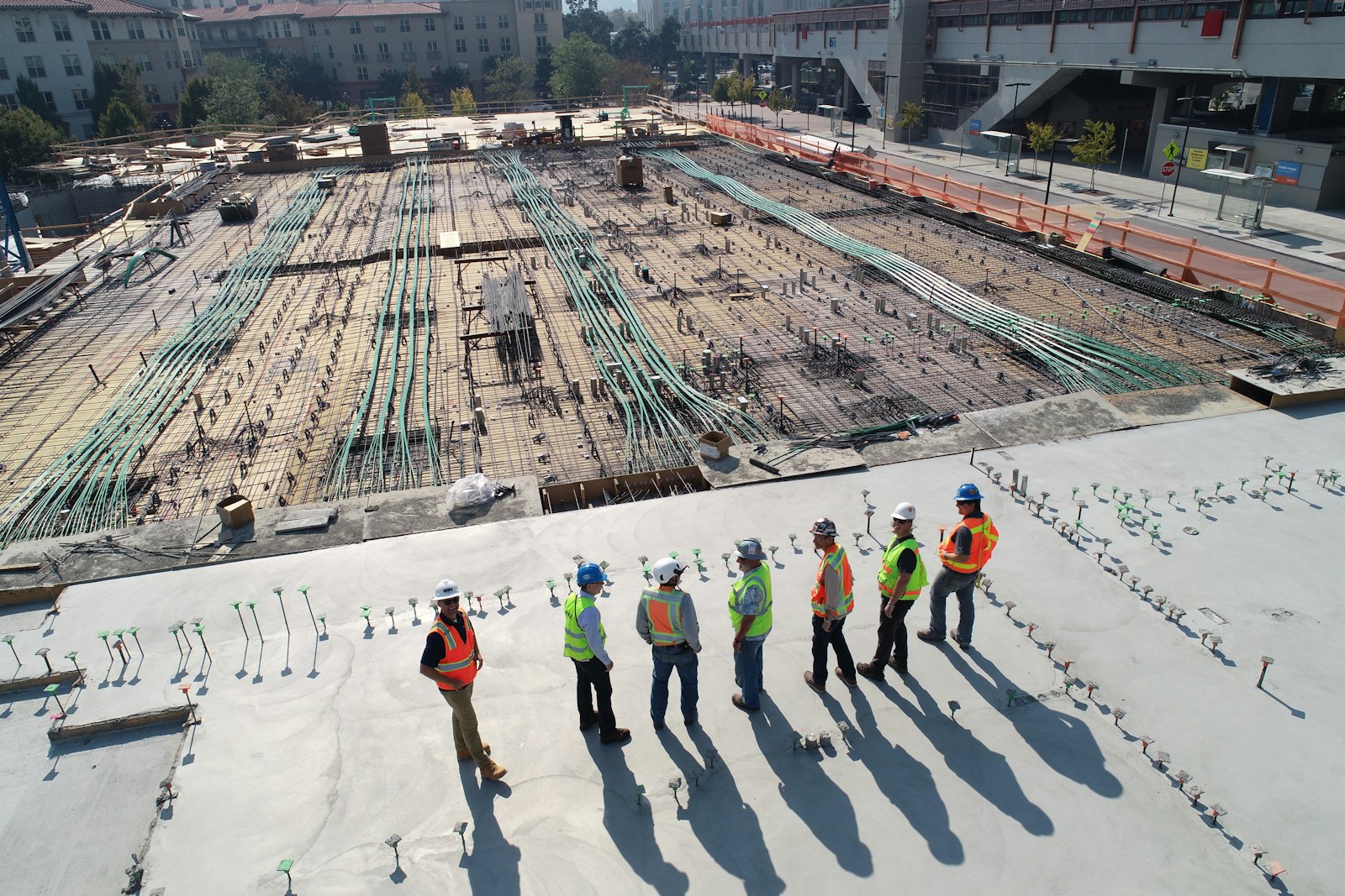 Construction team reviewing work on a reinforced concrete floor slab